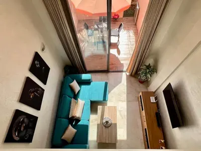 an overhead view of a living room with a blue couch at Beautiful Duplex Fast Wi-Fi Terrace Pool in Marrakech