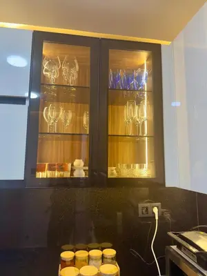 a kitchen with some glasses in a cabinet at Le Nid Hermès in Marrakech