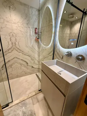 a bathroom with a sink and a shower at Le Nid Hermès in Marrakech