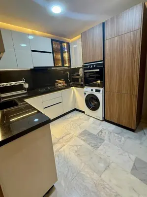 a kitchen with a washer and a washing machine at Le Nid Hermès in Marrakech