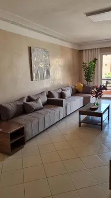 a living room with a couch and a coffee table at Happy Relaxing home in Marrakech
