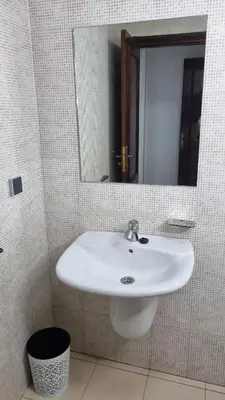 a bathroom with a white sink and a mirror at Happy Relaxing home in Marrakech
