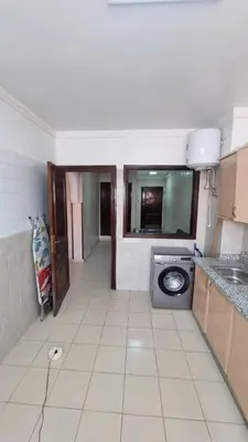 a kitchen with a sink and a washing machine at Happy Relaxing home in Marrakech