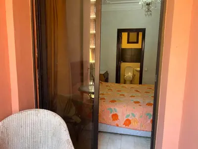 a room with a bedroom with a bed and a mirror at Résidence belle vie 6 avec piscine in Marrakech