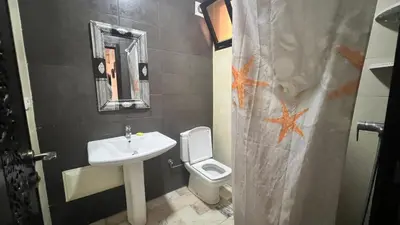 a bathroom with a sink and a toilet at Résidence belle vie 6 avec piscine in Marrakech