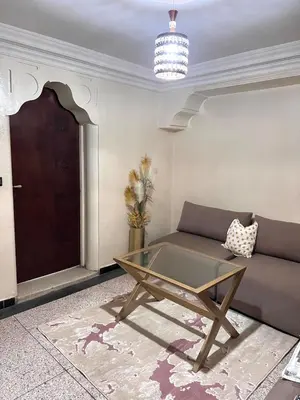 a living room with a couch and a glass table at Apartment in the center of Marrakesh in Marrakech