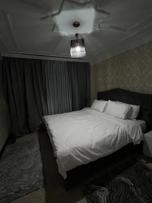 a bedroom with a white bed with a ceiling at Apartment in the center of Marrakesh in Marrakech
