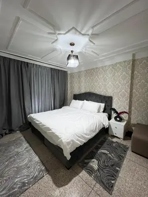 a bedroom with a large bed with a ceiling at Apartment in the center of Marrakesh in Marrakech