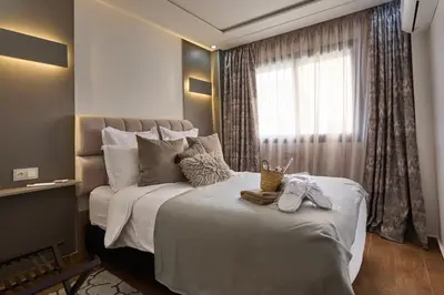 a bedroom with a large bed with a window at Super duplexe en plein Marrakech in Marrakech