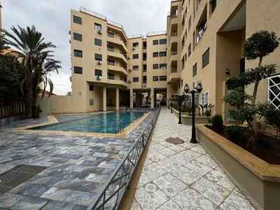 a swimming pool in the courtyard of a building at Super duplexe en plein Marrakech in Marrakech