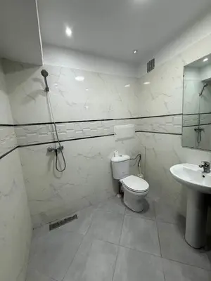 a white bathroom with a toilet and a sink at Apartment in the heart of Gueliz in Marrakech