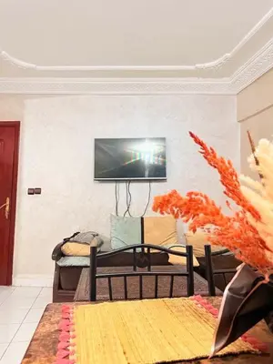 a living room with a flat screen tv on a wall at Apartment in the heart of Gueliz in Marrakech