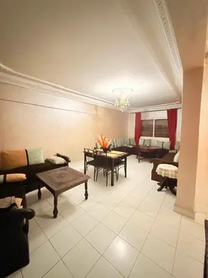 a living room with couches and a table and chairs at Apartment in the heart of Gueliz in Marrakech