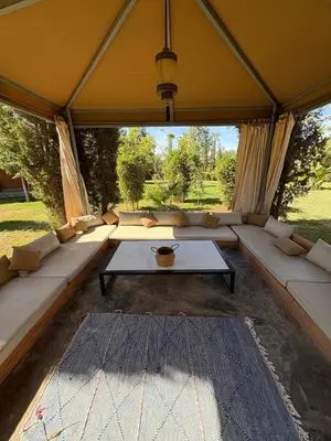 a living room with a couch in a tent at Villa Sofia And Spa in Marrakech