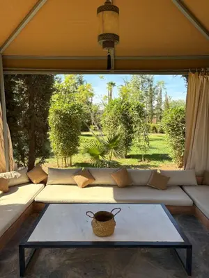a living room with a couch and a table at Villa Sofia And Spa in Marrakech