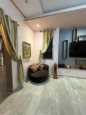 a living room with a couch and a flat screen tv at Villa Sofia And Spa in Marrakech