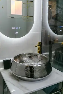 a bathroom with a silver sink on a counter at Riad 3ch, proche Médina, résidence avec piscines in Marrakech