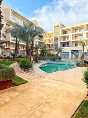 a resort with a swimming pool and palm trees at Marrakech apartment with pool - Pearl Garden in Marrakech