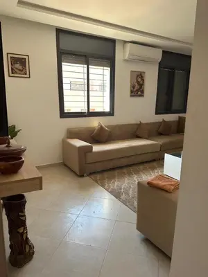 a living room with a couch and a table at Marrakech Nice Apartment- Central Marrakech in Marrakech