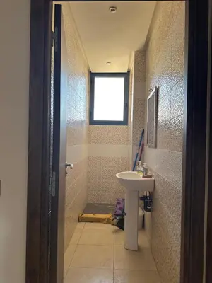 a bathroom with a sink and a shower with a window at Marrakech Nice Apartment- Central Marrakech in Marrakech