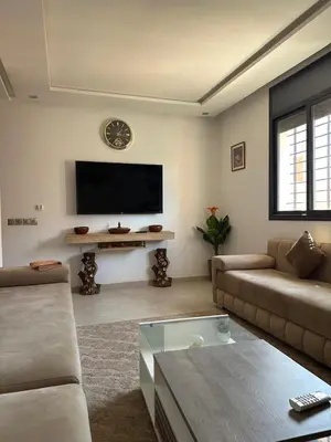 a living room with a couch and a tv at Marrakech Nice Apartment- Central Marrakech in Marrakech