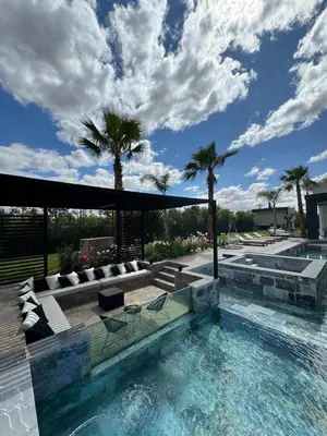 a swimming pool with palm trees in the background at Villa Bora in Marrakech