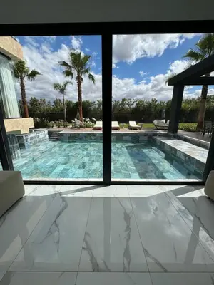 a view of a swimming pool through a window at Villa Bora in Marrakech