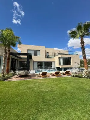 a house with palm trees in front of a yard at Villa Bora in Marrakech