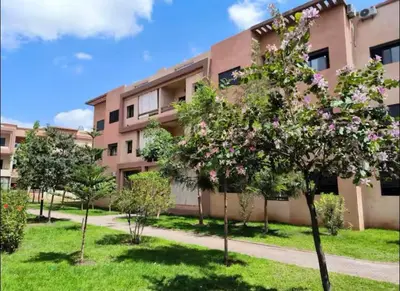 an apartment building with trees in front of it at Appartement lumineux & élégant avec accès piscine in Marrakech