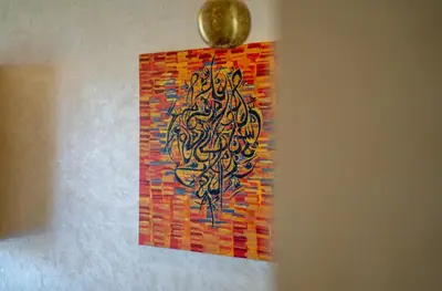 a painting hanging on a wall with a gold ornament at Two bedroom apartment on golf resort near airport in Marrakech