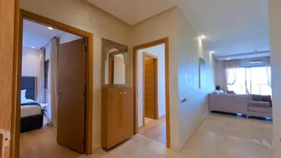 a hallway with two doors and a living room at Two bedroom apartment on golf resort near airport in Marrakech