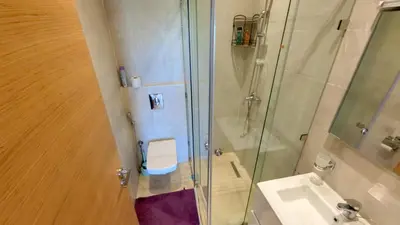 a bathroom with a shower and a toilet and a sink at Two bedroom apartment on golf resort near airport in Marrakech