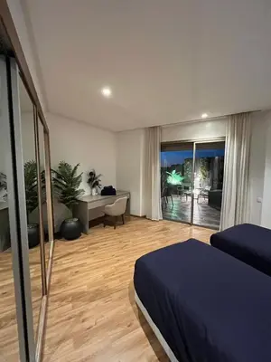 a bedroom with a bed and a view of a patio at Charmant appartement lumineux au cœur de la ville in Marrakech