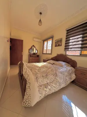 a bedroom with a large bed in a room at Modern apartment, 10 minutes from the airport in Marrakech