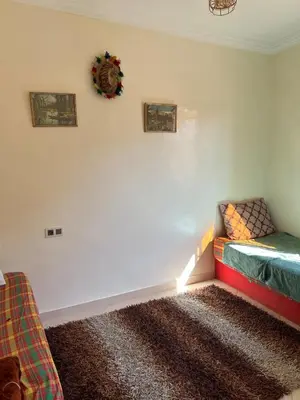 a room with a bed with a light on the wall at Modern apartment, 10 minutes from the airport in Marrakech