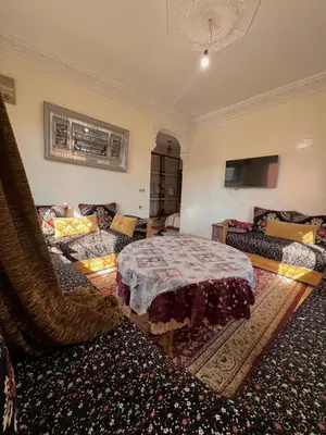 a living room with a bed and a couch at Modern apartment, 10 minutes from the airport in Marrakech