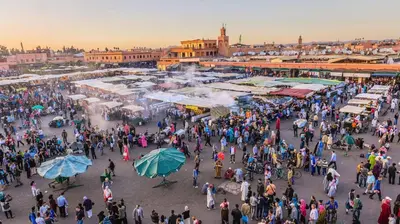 a large crowd of people walking around a market at Appartement ECHRIFIA GARDENS in Marrakech