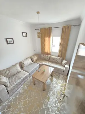 a living room with a couch and a coffee table at Appartement ECHRIFIA GARDENS in Marrakech