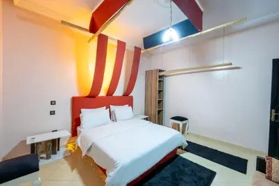 a bedroom with a bed with a red headboard at Dar Yassan in Marrakech