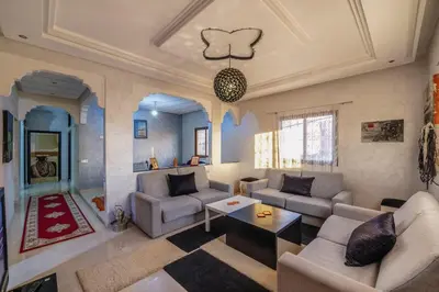 a living room with two couches and a table at Dar Yassan in Marrakech