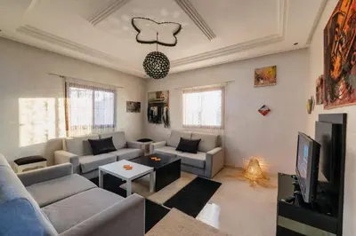 a living room with a couch and a tv at Dar Yassan in Marrakech