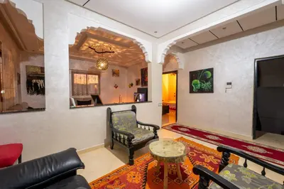 a living room with a couch and a chair and a table at Dar Yassan in Marrakech