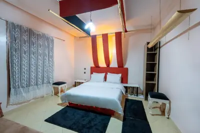 a bedroom with a bed and a ladder in it at Dar Yassan in Marrakech