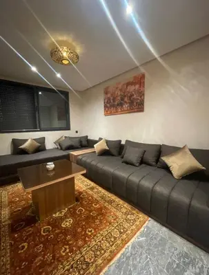 a living room with a couch and a table at Brg Immo in Marrakech