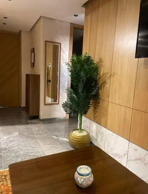 a lobby with a plant in a vase on a table at Brg Immo in Marrakech