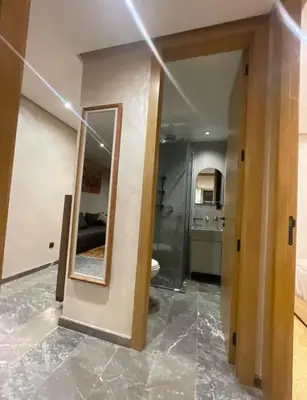 a bathroom with a mirror and a room with a toilet at Brg Immo in Marrakech