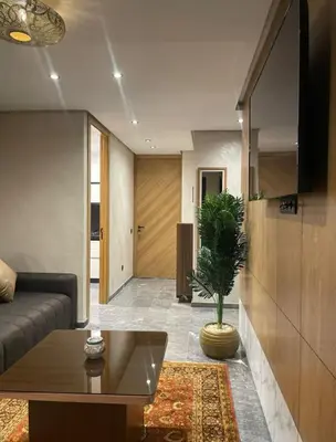 a living room with a couch and a potted plant at Brg Immo in Marrakech