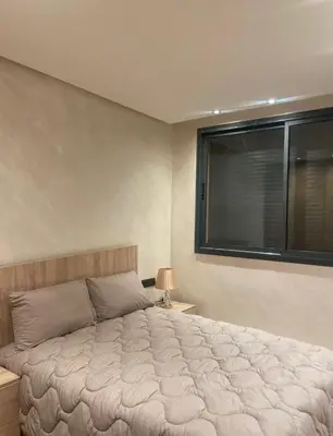 a bedroom with a large bed and a window at Brg Immo in Marrakech