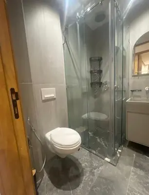 a bathroom with a toilet and a glass shower at Brg Immo in Marrakech