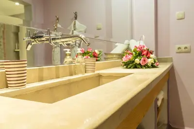 a bathroom with a sink with flowers on it at Riad Enchanté in Marrakech
